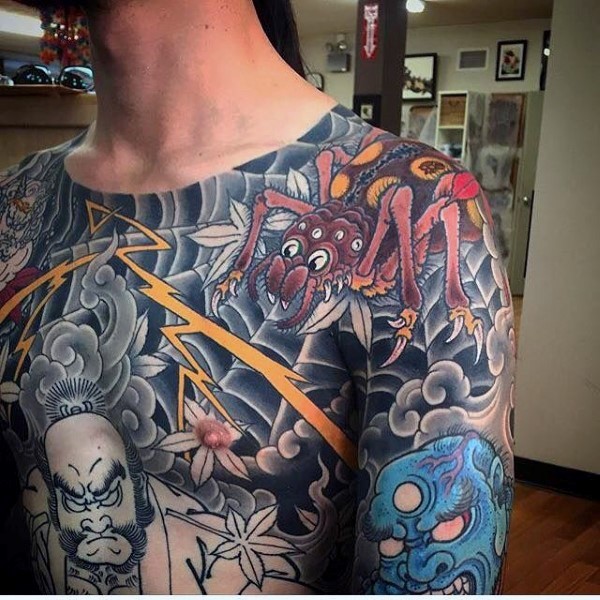 Old school style colored fantasy spider tattoo with various Asian demons