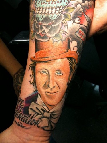 Old school style colored forearm tattoo of man in cylinder hat