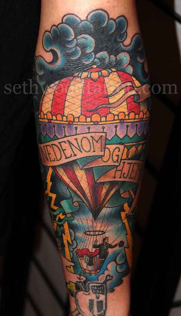 Old school style colored forearm tattoo of man with balloon and lettering