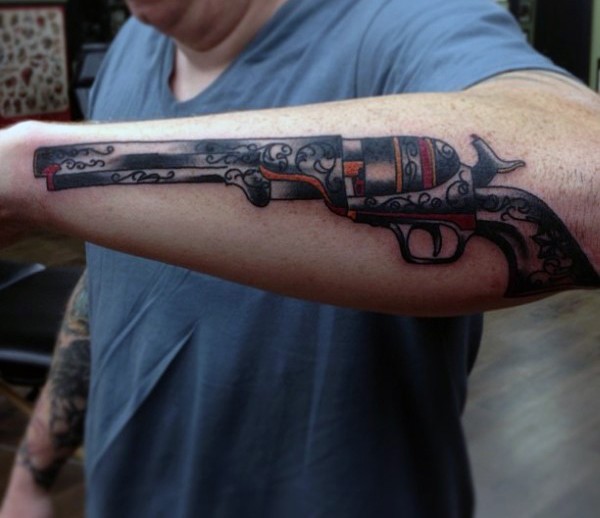 Old school style colored forearm tattoo of antic revolver