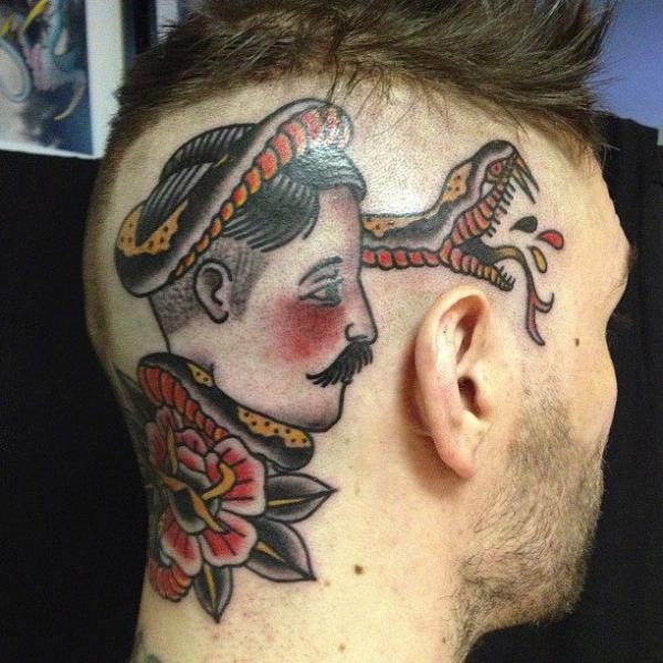 Old school style colored head tattoo of sailor face with snake and flower