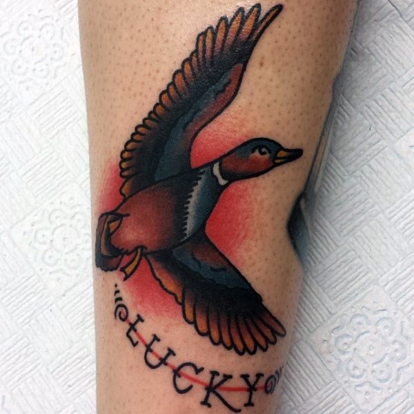 Old school style colored leg tattoo of flying duck