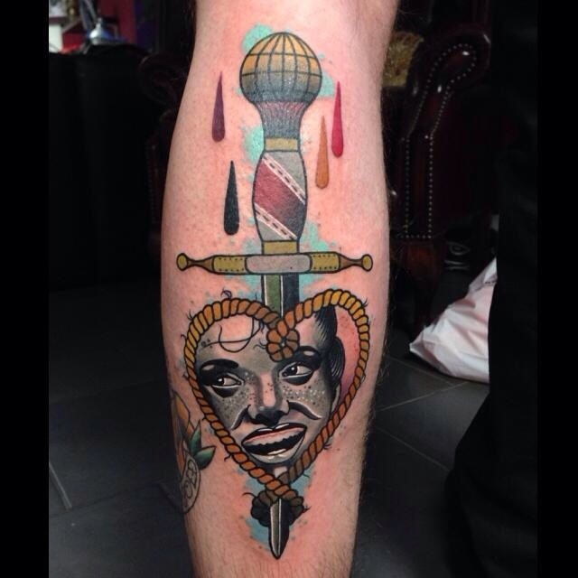 Old school style colored leg tattoo of dagger with rope and woman face