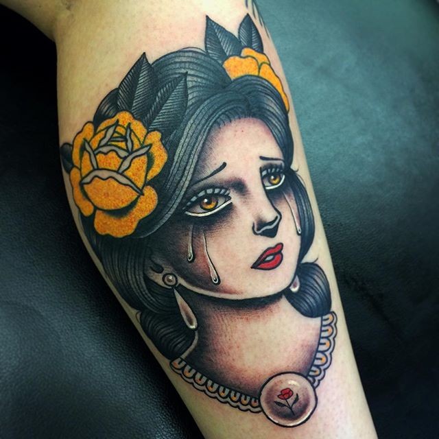 Old school style colored leg tattoo of crying woman with flowers