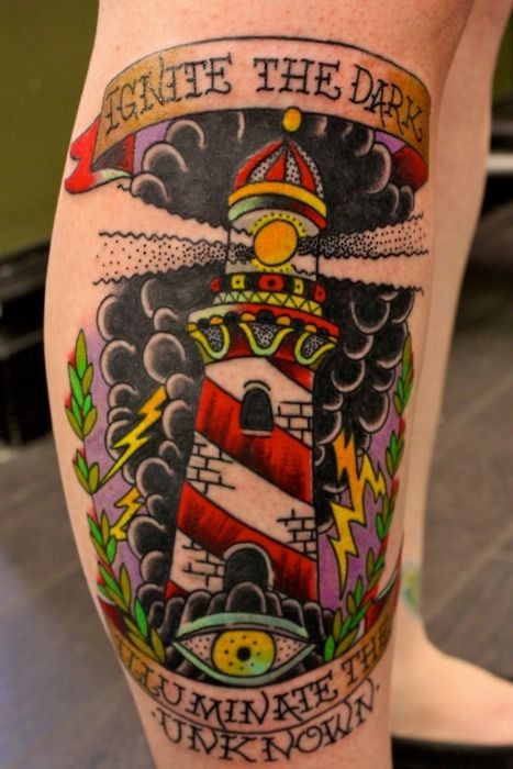Old school style colored leg tattoo of creepy lighthouse and lettering