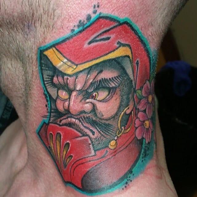 Old school style colored neck tattoo of angry daruma doll