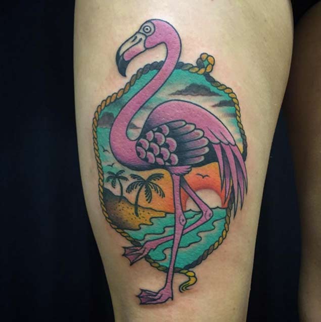 Old school style colored pink flamingo tattoo on thigh stylized with sea shore picture