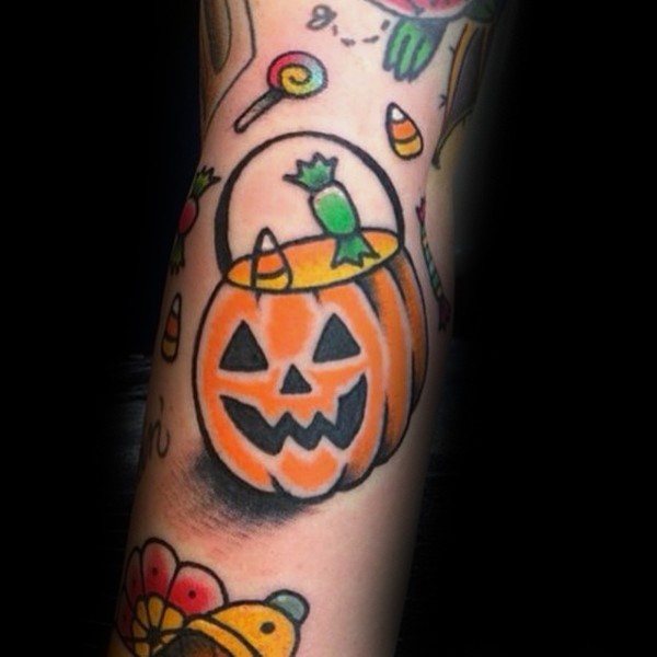 Old school style colored pumpkin basket tattoo with candles