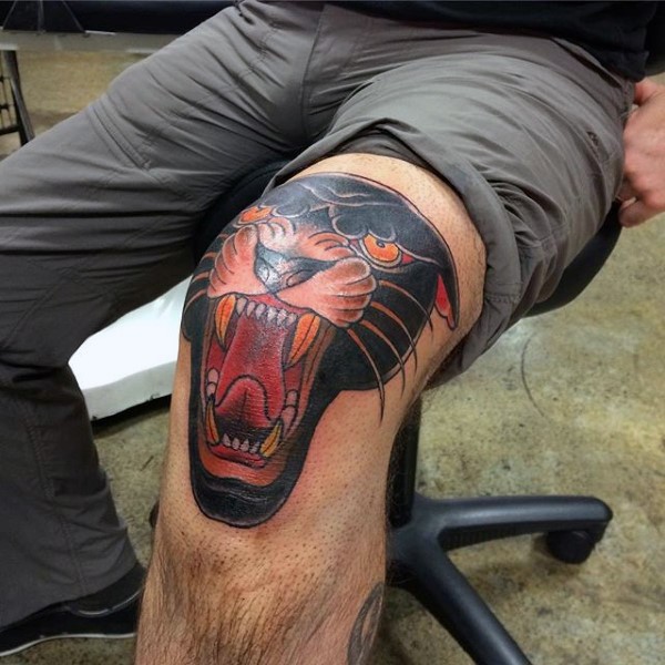 Old school style colored roaring black panther head knee tattoo