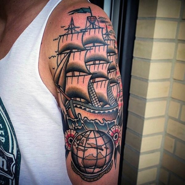 Old school style colored shoulder tattoo sailing ship with globe