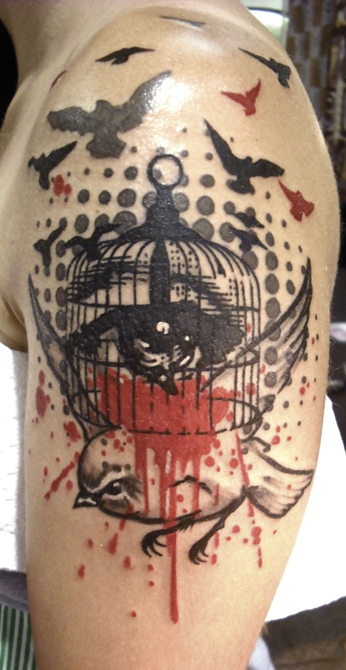 Old school style colored shoulder tattoo of small bird with cage