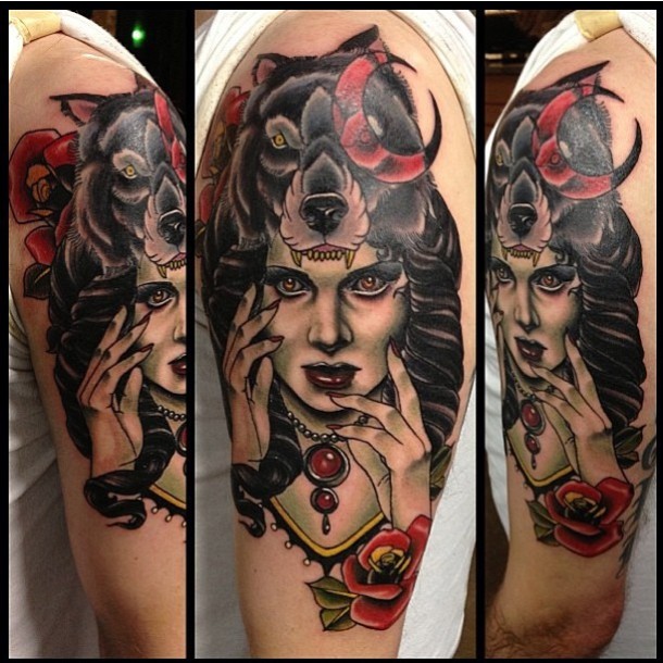Old school style colored shoulder tattoo of creepy witch with wolf helmet and flowers