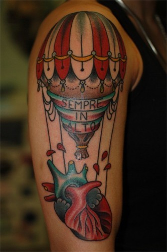 Old school style colored shoulder tattoo of human heart with balloon and lettering