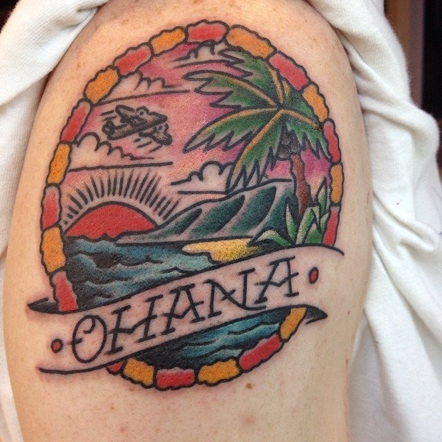 Old school style colored shoulder tattoo of ocean sunset with island and lettering