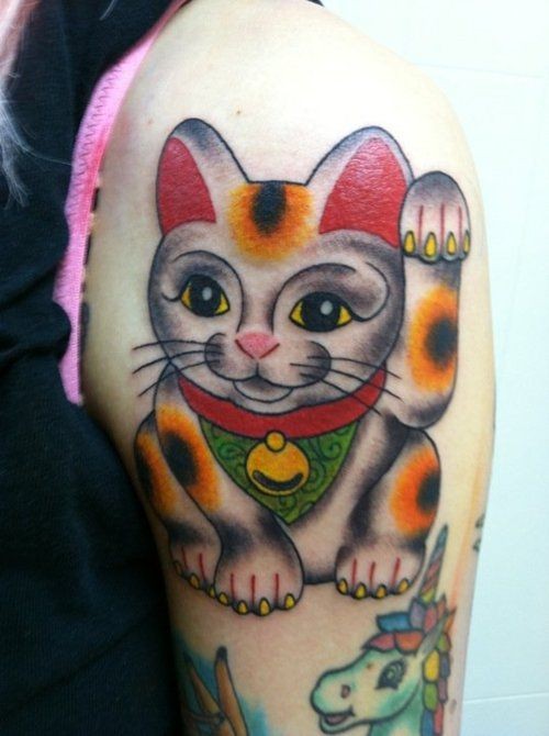 Old school style colored shoulder tattoo of maneki neko japanese lucky cat figure