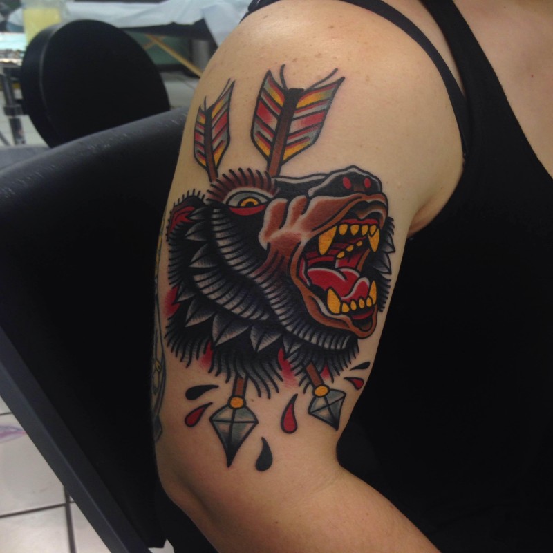 Old school style colored shoulder tattoo of big bear head with arrows