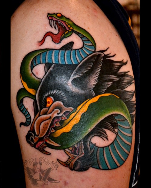 Old school style colored shoulder tattoo of evil dog with snake