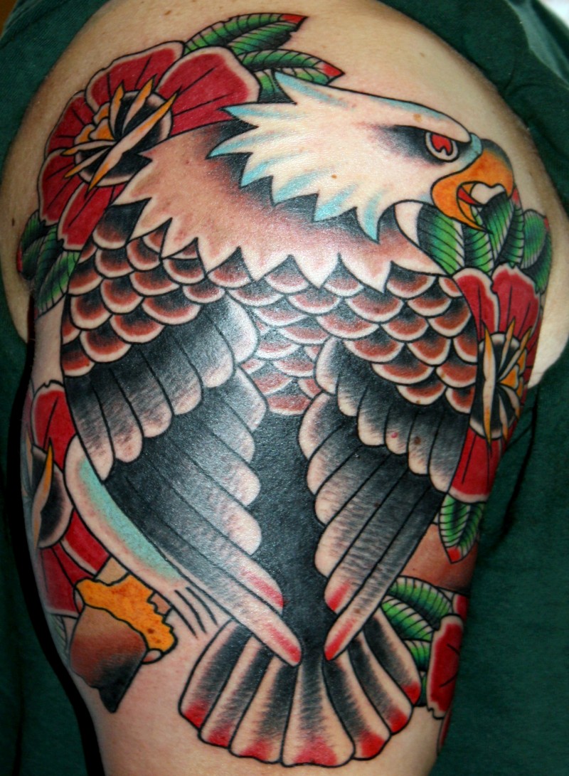 Old school style colored shoulder tattoo of typical eagle with flowers