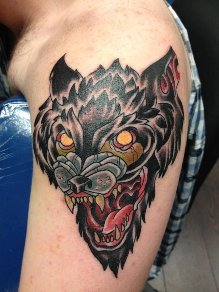 Old school style colored shoulder tattoo of evil dog head