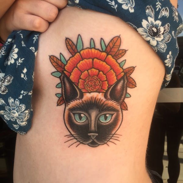 Old school style colored side tattoo of cat with flower