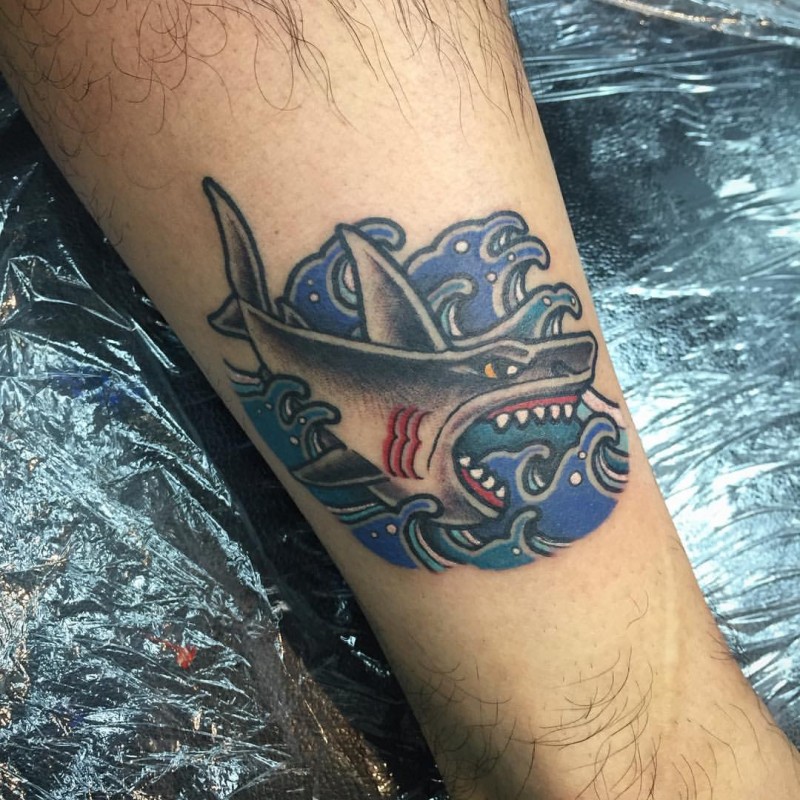 Old school style colored tattoo of evil shark with waves