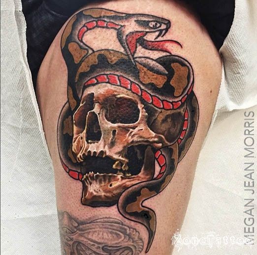 Old school style colored thigh tattoo of human skull stylized with evil snake