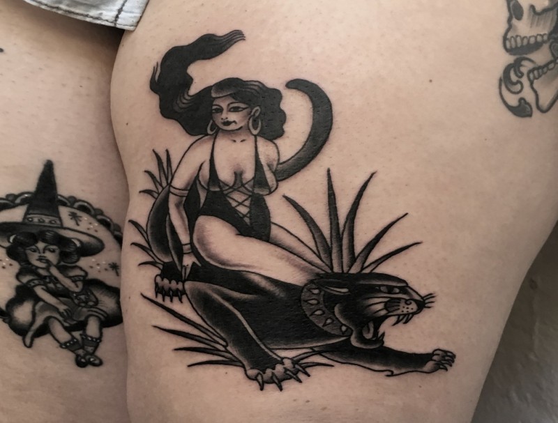 Old school style colored thigh tattoo of sexy woman with black panther