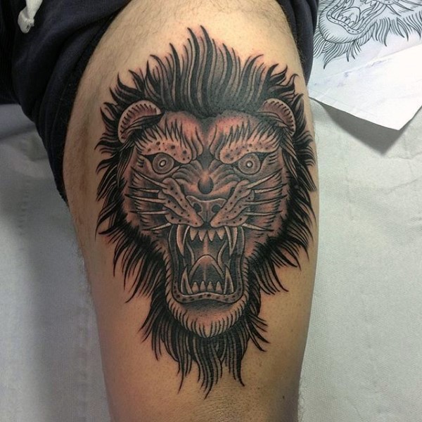Old school style colored thigh tattoo of lion head