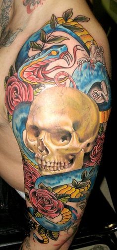 Old school style colorful human skull with snake and mouse tattoo on shoulder with flowers