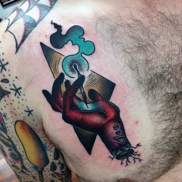 Old school style colorful mystical hand tattoo on chest with triangle