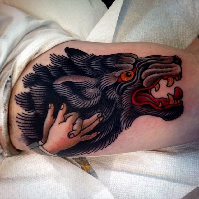 Old school style cute looking biceps tattoo of demonic wolf