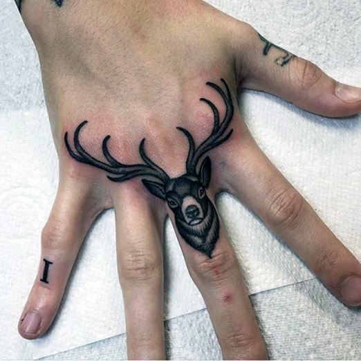 Old school style deer&quots head with giant horns tattoo on middle finger and hand