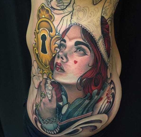Old school style designed colorful mystical clown like woman tattoo on side combined with golden lock