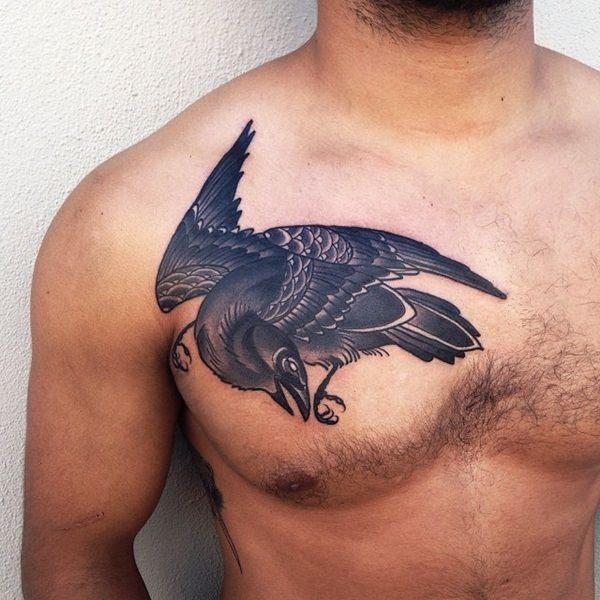 Old school style detailed stylized black crow tattoo on man&quots chest
