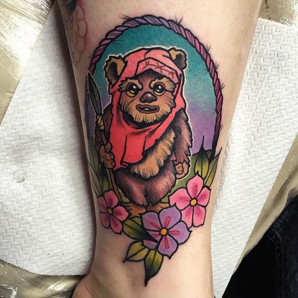 Old school style funny colored ewok portrait tattoo with flowers