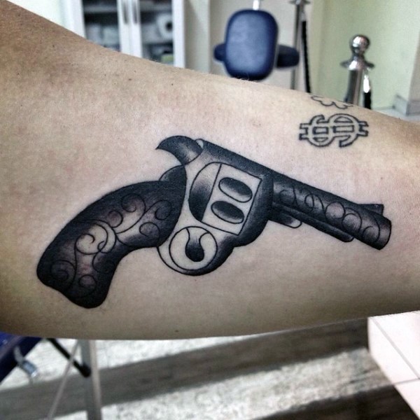 Old school style gun tattoo on biceps