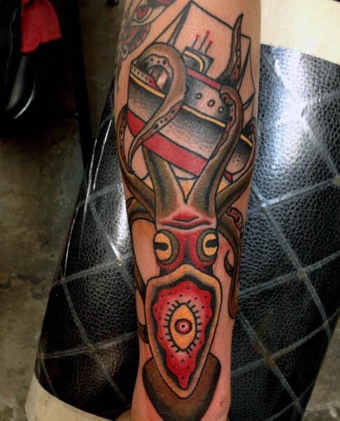 Old school style multicolored squid with ship tattoo on sleeve