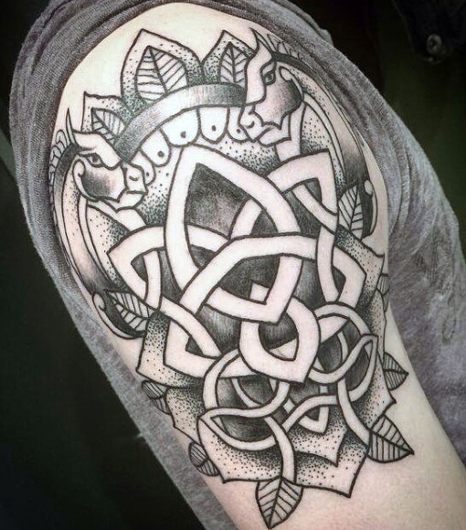 Old school style painted black and white Celtic emblem tattoo on arm