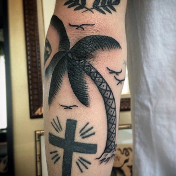Old school style painted black ink palm tree tattoo on elbow