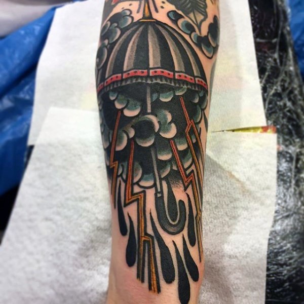 Old school style painted colored rain from umbrella tattoo on arm