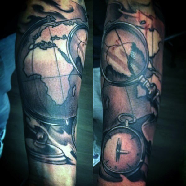 Old school style painted colored world map with compass and loupe tattoo on arm