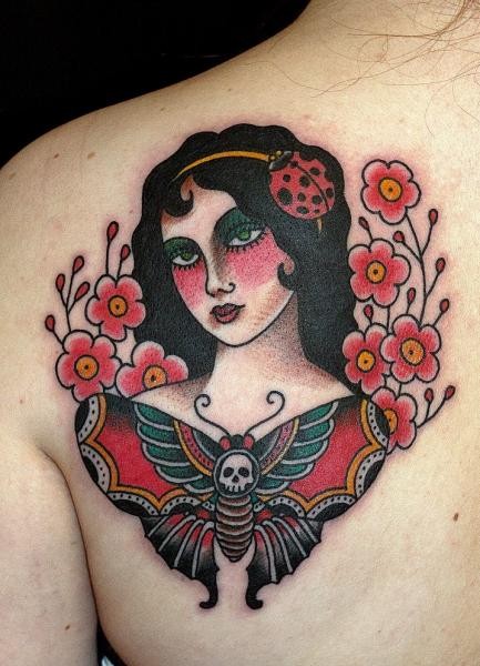 Old school style scapular tattoo of woman with flowers and butterfly