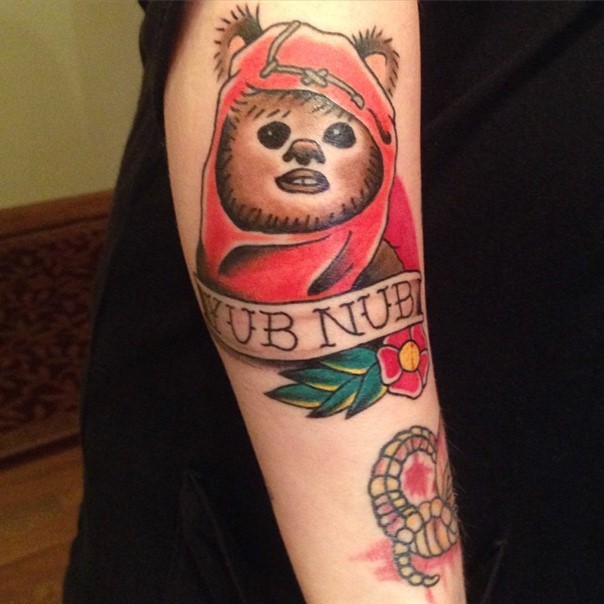 Old school very realistic looking Star Wars little hero portrait tattoo on forearm stylized with lettering and flower