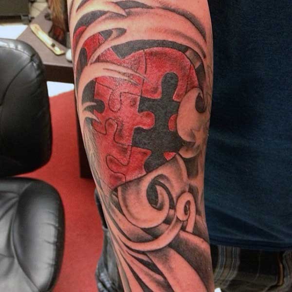 Old scroll illustrative style forearm tattoo of puzzle