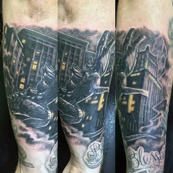Old style cartoon like colored Godzilla in city tattoo on arm
