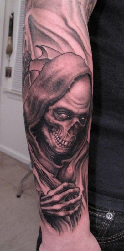 Ominous grim reaper forearm tattoo