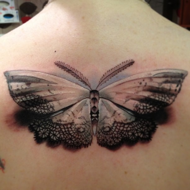 Openwork tender colored moth tattoo