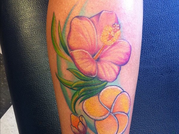 Orange hibiscus flowers tattoo on leg