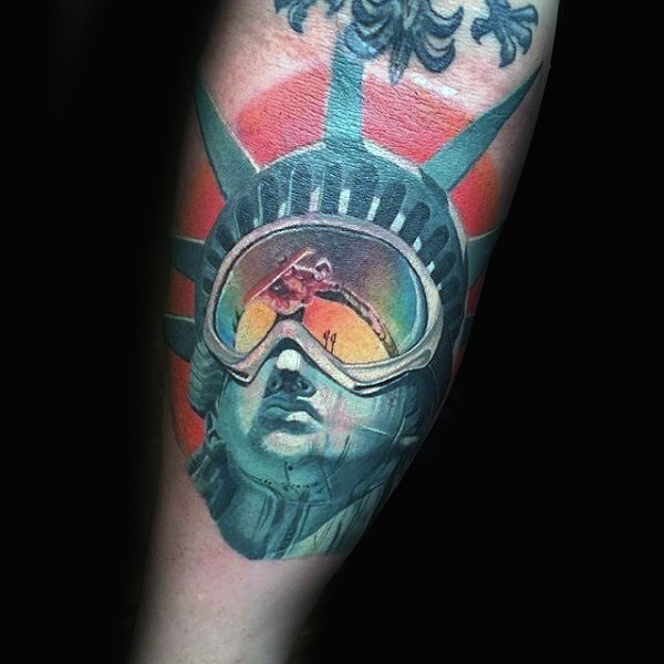 Original designed and colored arm tattoo of Statue of Liberty with snowboard glasses