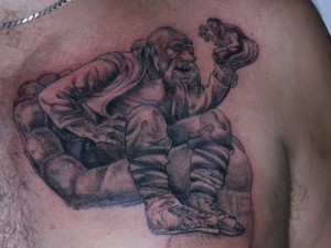Original designed black ink man-holding-man tattoo on chest